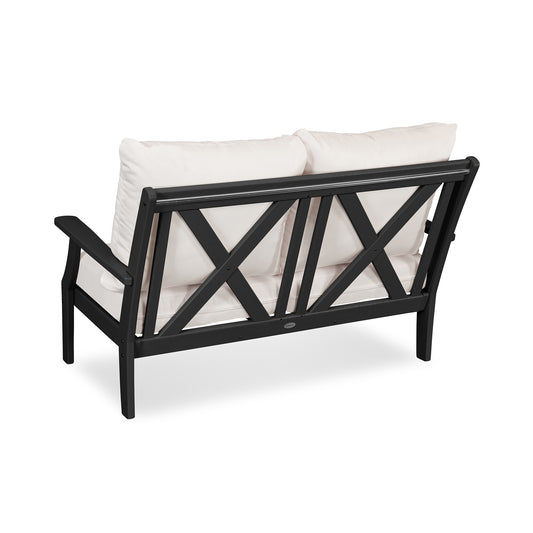 POLYWOOD Braxton Deep Seating Settee with crisscross back and plush white cushions, crafted from recycled plastic.