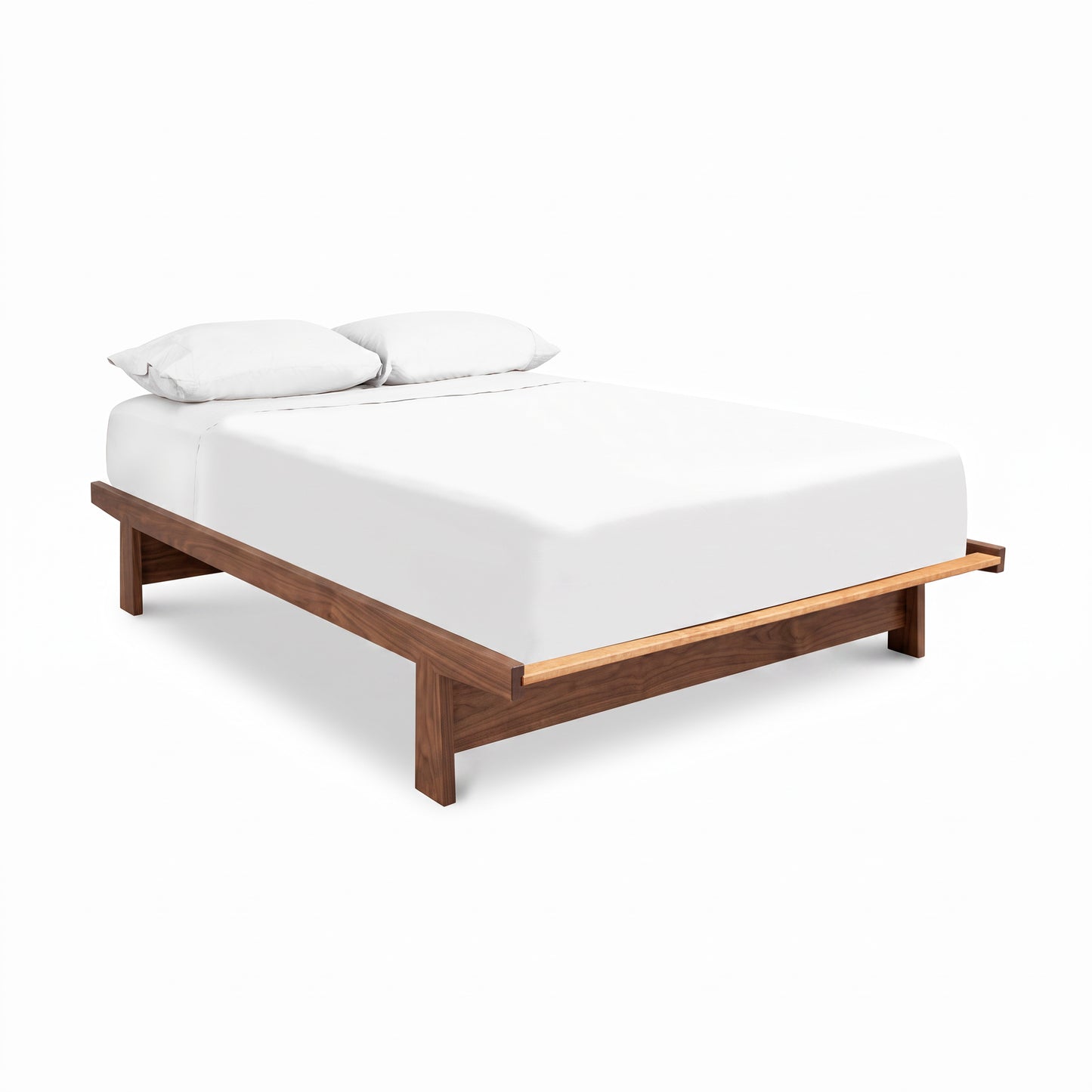 Cherry Moon Dovetail Platform Bed by Maple Corner Woodworks showcases fine craftsmanship and dovetail joinery, highlighted with simple white bedding.
