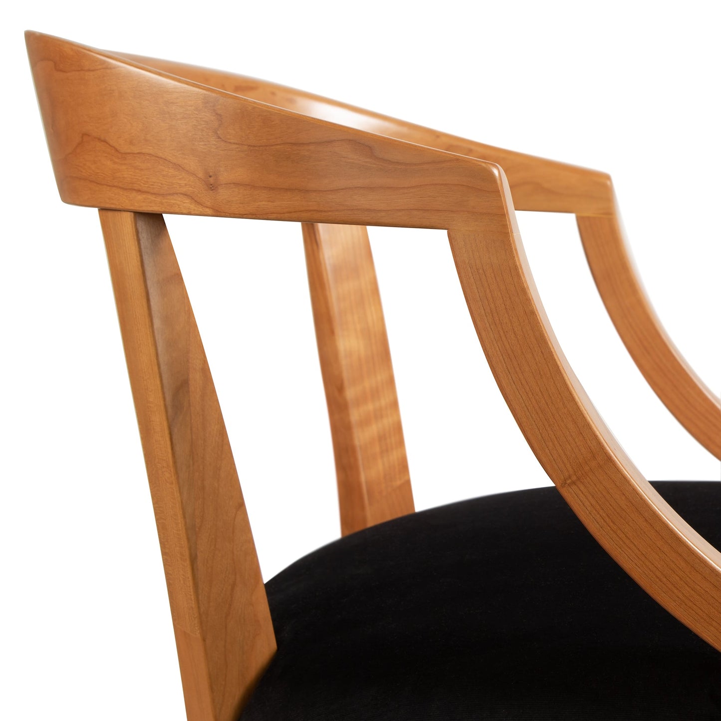 Dorset Chair by Vermont Woods Studios featuring elegant curved armrests and black upholstery, highlighting its refined design and craftsmanship.