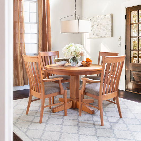 Lyndon Furniture Natural Vermont round pedestal table with solid top, paired with four matching chairs.