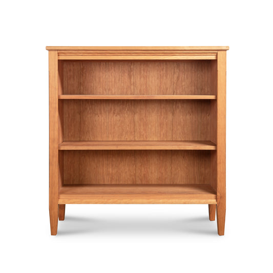 Vermont Shaker Bookcase with three empty shelves and tapered legs, crafted from sustainably harvested hardwoods, exemplifying the craftsmanship of the Vermont Shaker Furniture Collection.