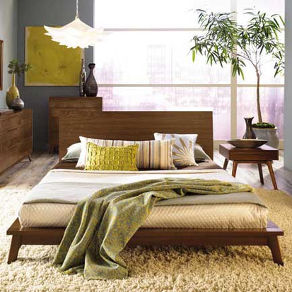 A bedroom with a bed and dresser.