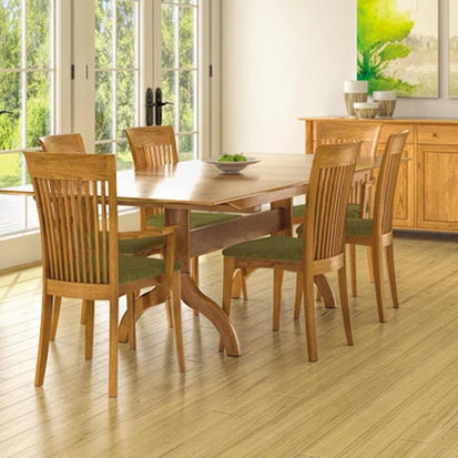 A dining room with a wooden table and chairs.