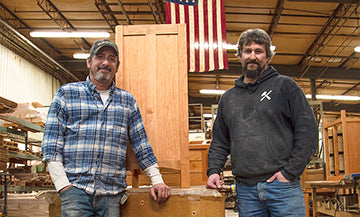 Handcrafted wooden furniture pieces in a woodworking shop.