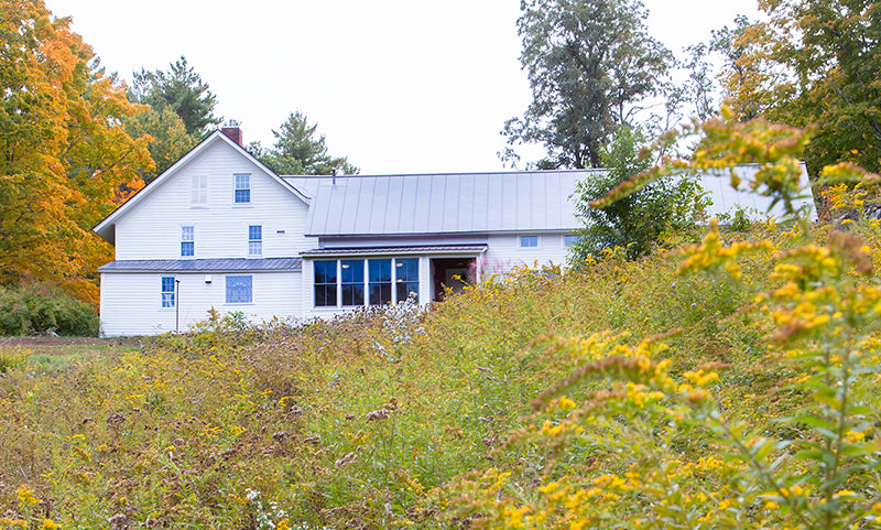 High-quality American-made white farmhouse furniture with a sleek metal roof design.