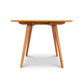 Vermont-crafted Addison Boat Top Extension Dining Table with round top and angled legs by Lyndon Furniture, viewed straight-on.