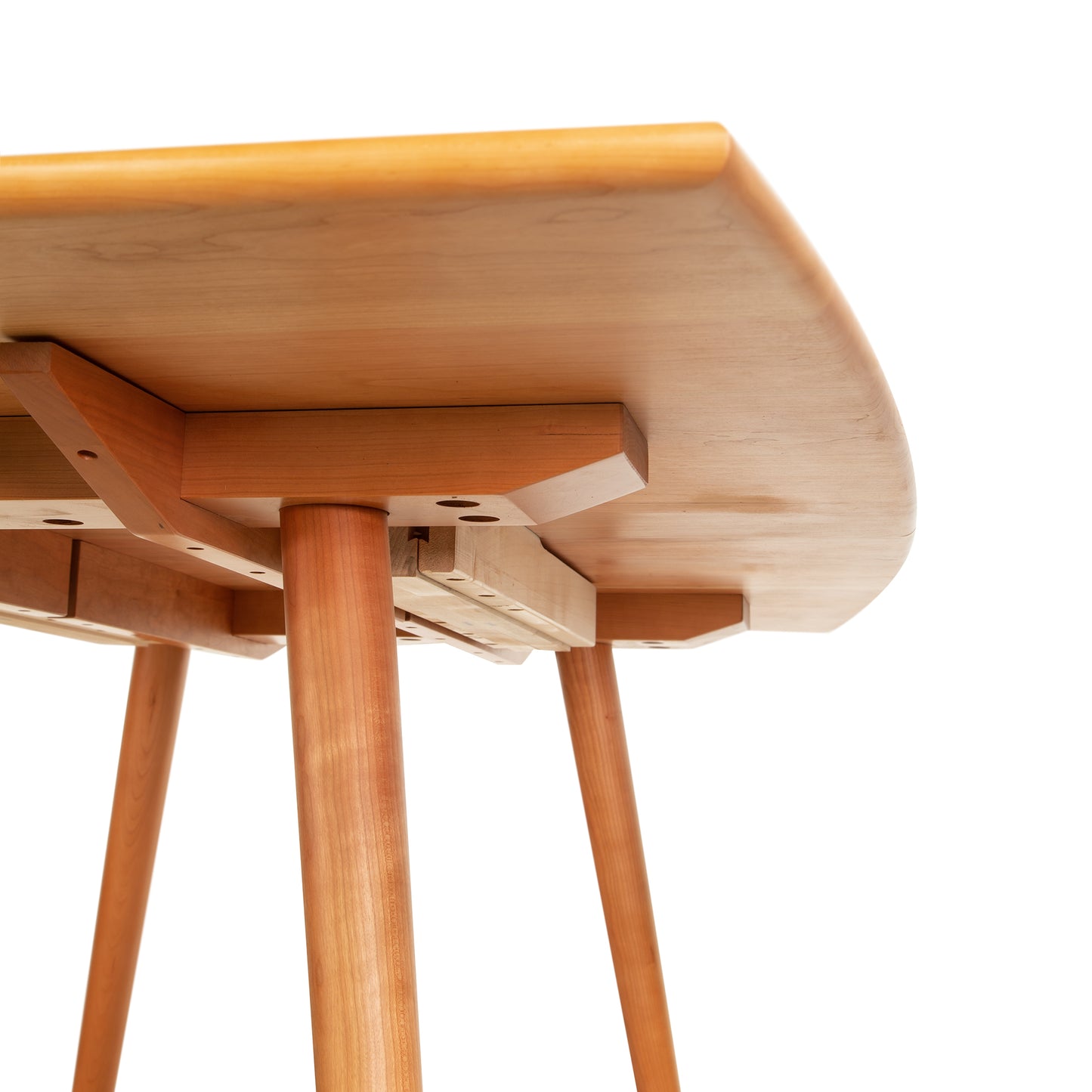 Underside view of the Vermont Addison Boat Top Extension Dining Table by Lyndon Furniture, highlighting its handcrafted support and legs.