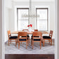 Addison Boat Top Extension Table by Lyndon Furniture with six chairs featuring black cushions.