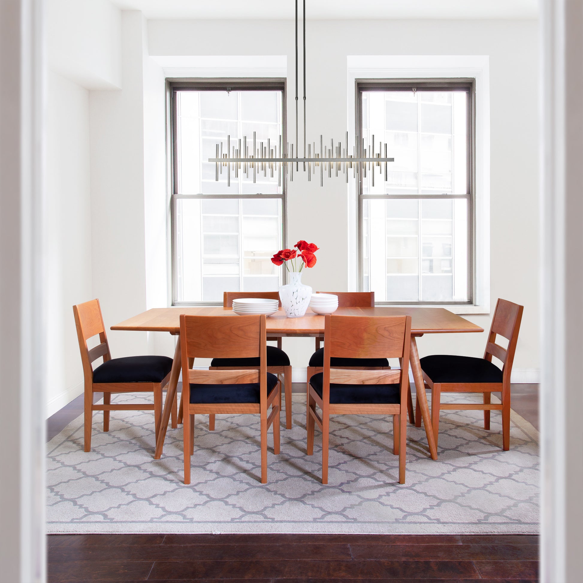 Addison Boat Top Extension Table by Lyndon Furniture with six chairs featuring black cushions.
