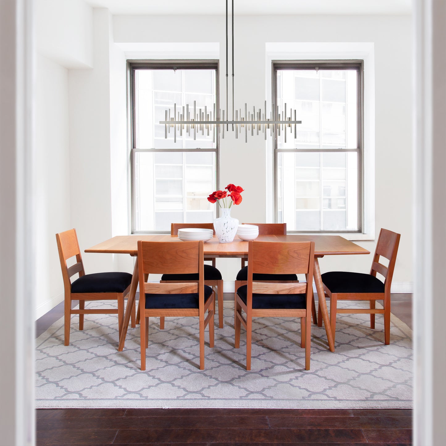 Burke Modern Chair with black upholstery, crafted by Vermont Woods Studios, showcases contemporary American design and expert craftsmanship.