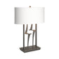 Antasia #1 Table Lamp by Hubbardton Forge featuring a sculptural metal base and white shade, showcasing a handcrafted modern design.