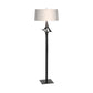 Antasia Floor Lamp by Hubbardton Forge featuring a slender black metal base and white fabric drum shade, highlighting expert craftsmanship and elegant modern design.