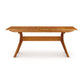 Audrey Extension Dining Table by Copeland Furniture, crafted from solid cherry wood with distinctive angled legs and a sturdy support beam.