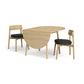 Baton Drop-Leaf Dining Table by Copeland Furniture paired with two black-cushioned Mid-Century Modern chairs, American made.