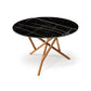 Baton Round Sintered Stone Top Table by Copeland Furniture with black marble surface, gold veining, and intersecting solid wood legs. American made.
