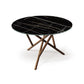 Baton Round Table by Copeland Furniture features a modern sintered stone top and intersecting wooden legs, handcrafted in America for lasting quality.