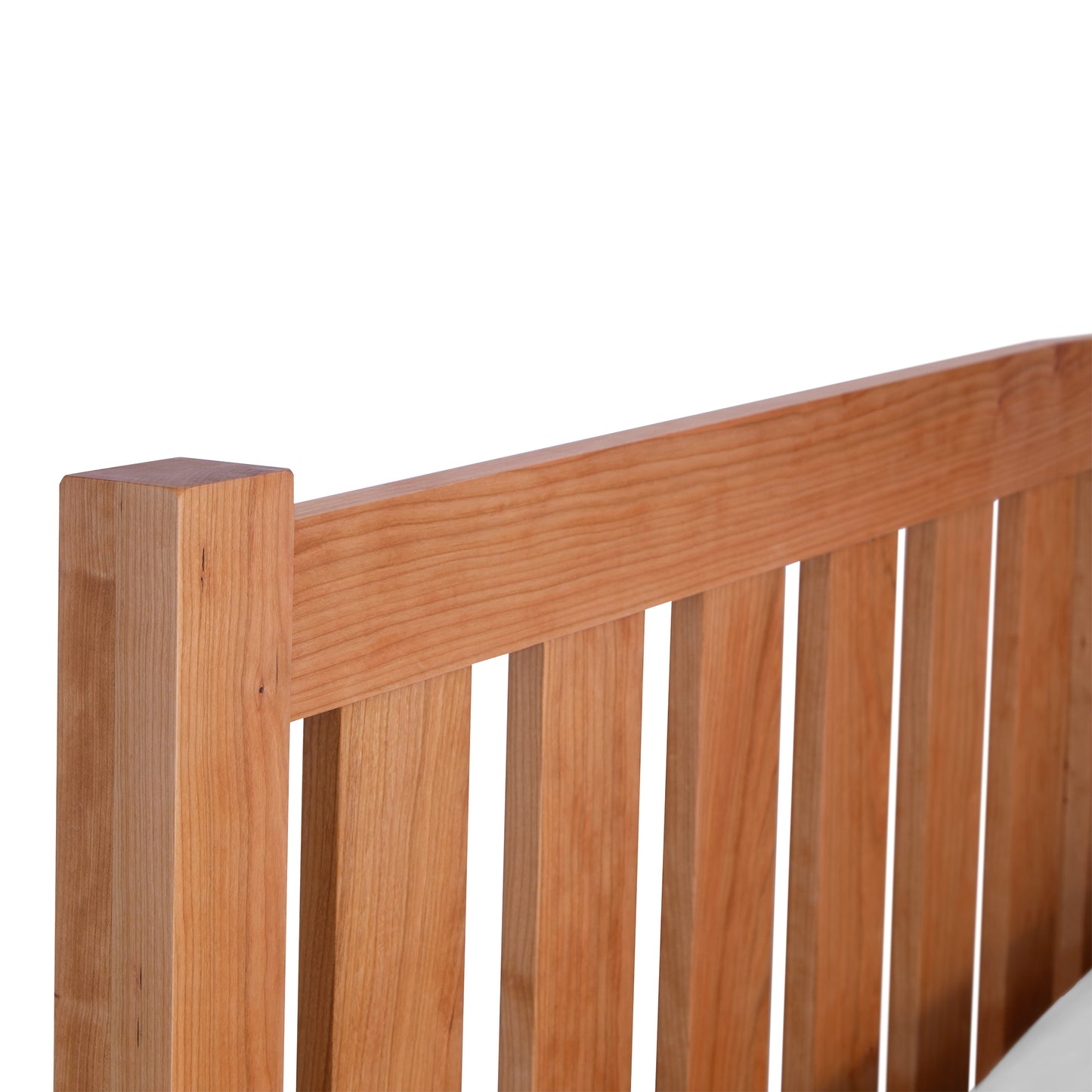 Bennington Bed by Vermont Furniture Designs with a striking wooden headboard featuring vertical slats, available in cherry or walnut.
