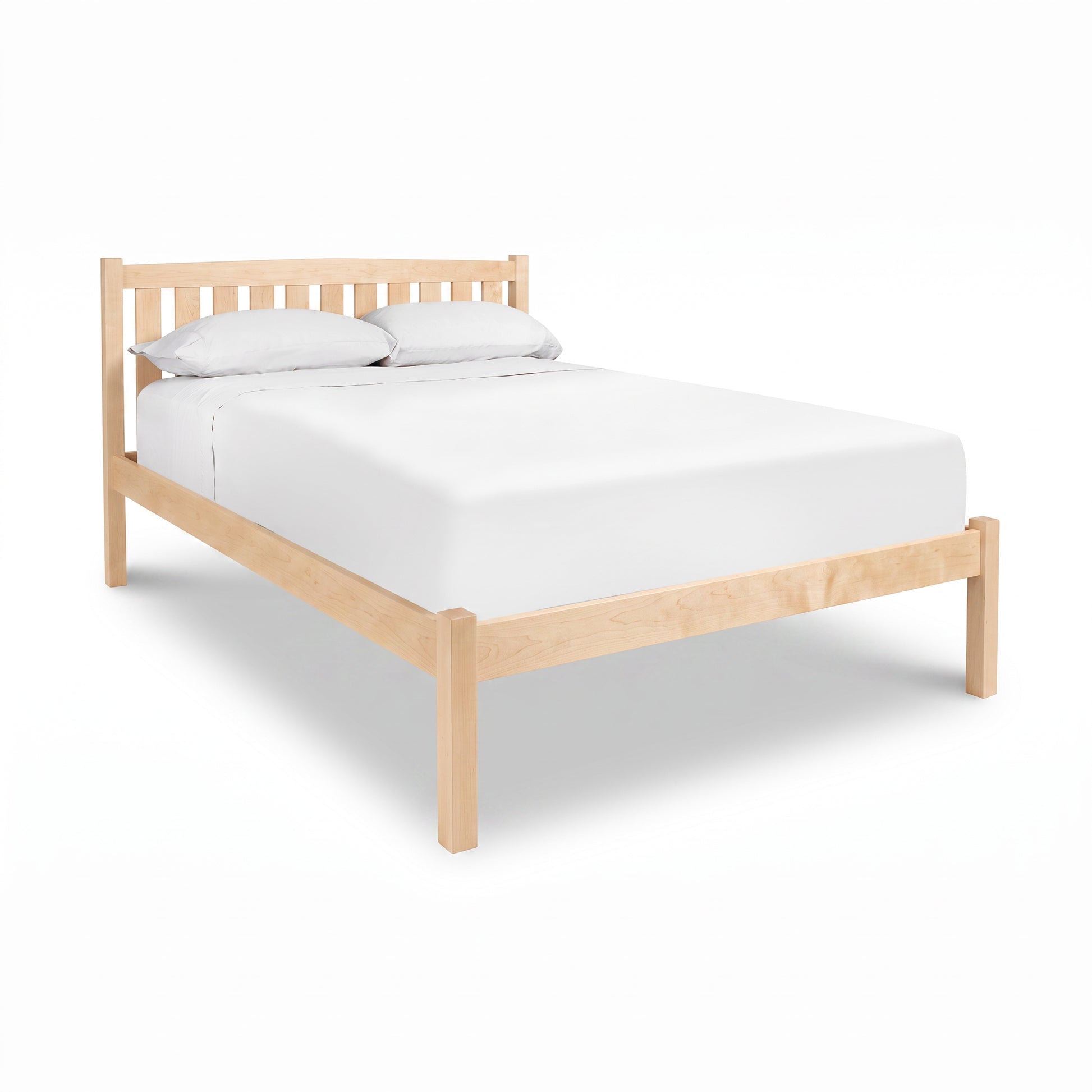 Bennington Bed with low footboard by Vermont Furniture Designs, shown with white mattress and pillows. Handcrafted hardwood, American made.