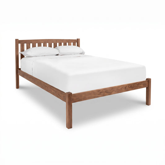 Bennington Bed with Low Footboard by Vermont Furniture Designs, featuring a white mattress and pillows, crafted in solid wood.