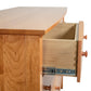 Lyndon Furniture Bow Front 6-Drawer Dresser featuring an open drawer that highlights dovetail joinery and sturdy metal slides.
