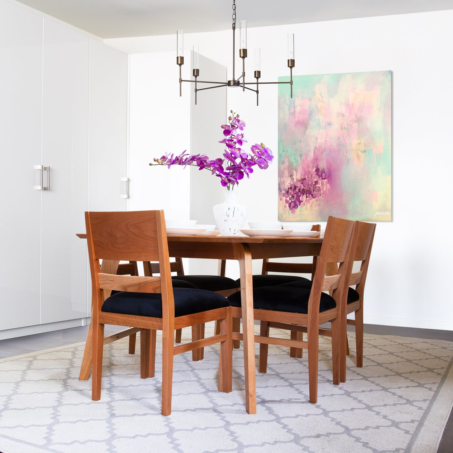 Burke Modern Chairs by Vermont Woods Studios surround a wood dining table, showcasing American made craftsmanship in a contemporary dining setting.