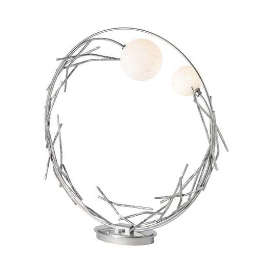 The Brindille Ring Lamp by Hubbardton Forge showcases a birch-inspired metal frame and two white globe bulbs, highlighting fine American craftsmanship.