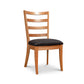 Bromley Ladder-Back Chair by Vermont Woods Studios with black upholstered seat and natural wood frame, crafted in America.