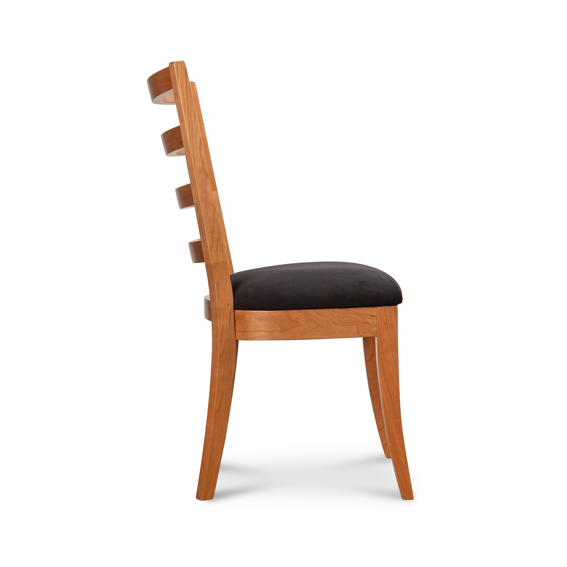 Bromley Ladder-Back Chair by Vermont Woods Studios with black upholstery, shown from the side to highlight its craftsmanship and elegant design.