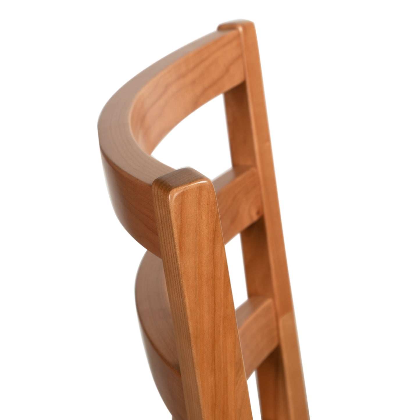 Bromley Ladder-Back Chair from Vermont Woods Studios featuring a curved wood backrest and sleek black upholstered seat, handcrafted in the USA.