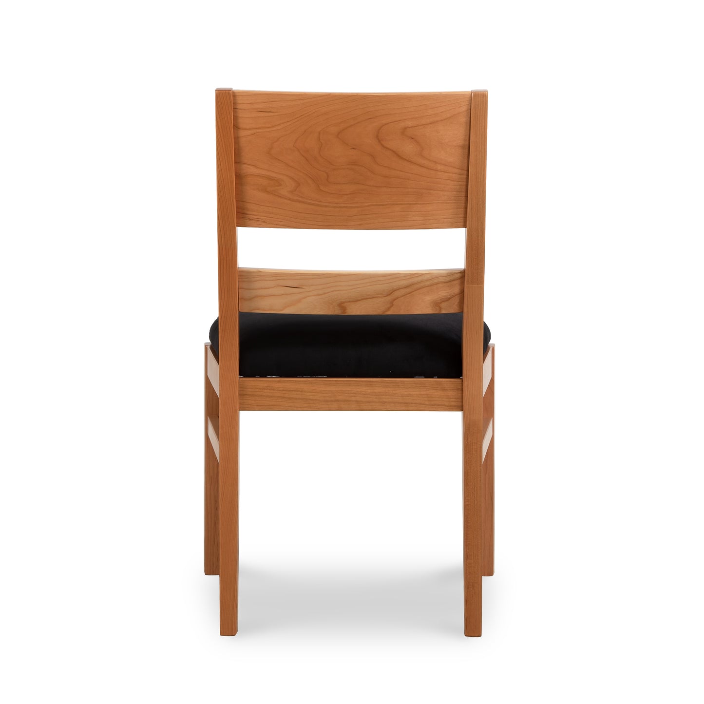Burke Modern Chair by Vermont Woods Studios featuring sleek black upholstery and straight backrest, highlighted from the rear view.