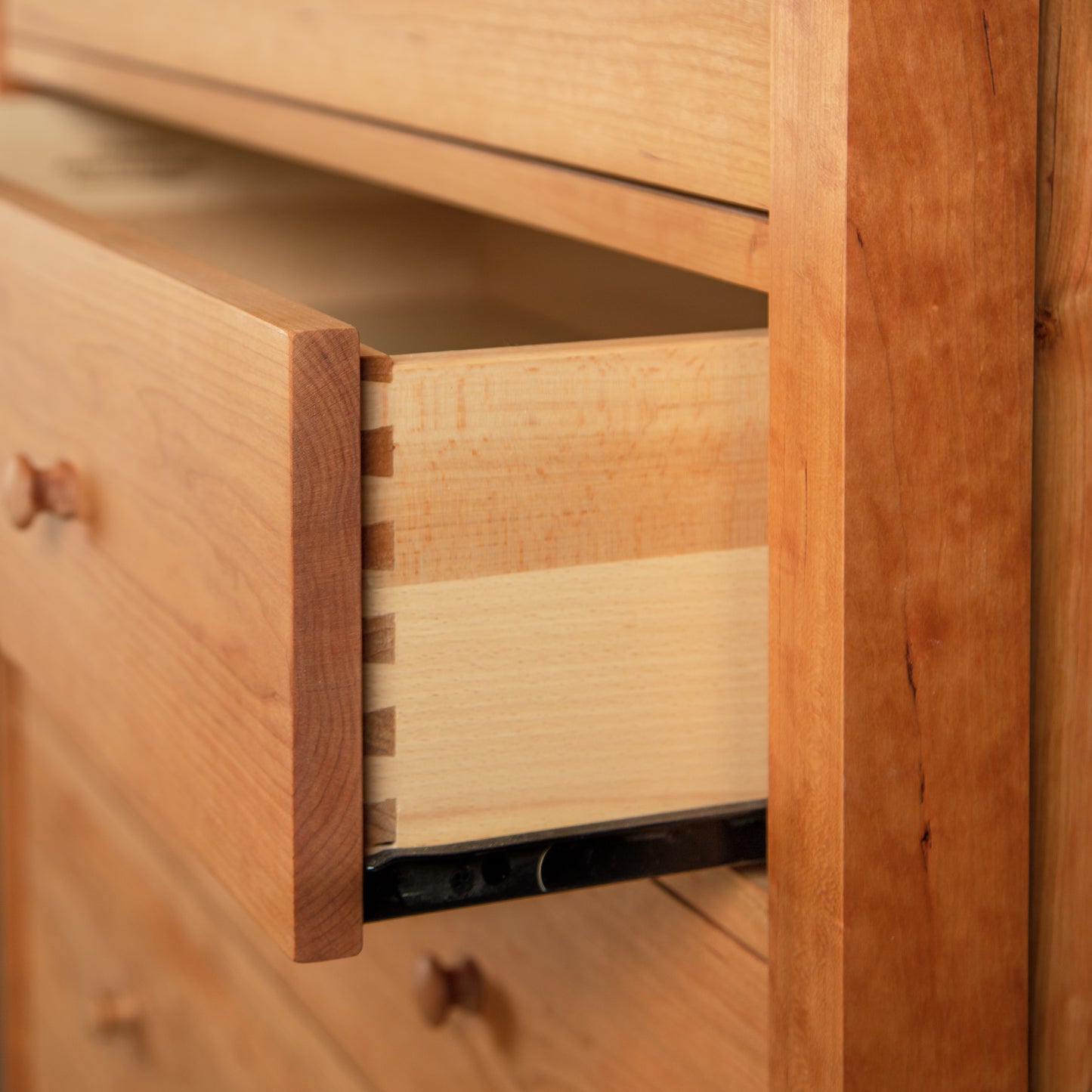 Vermont Furniture Designs Burlington Shaker 6-Drawer Chest in solid wood, featuring one open drawer with visible dovetail joinery craftsmanship.