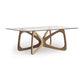 Butterfly Glass Top Dining Table by Copeland Furniture with a sculptural hardwood base and clear tempered glass top, displayed against a plain background.