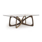 Butterfly Glass Top Dining Table by Copeland Furniture with a sculptural hardwood base and clear tempered glass top, showcasing elegant American craftsmanship.