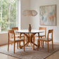 Butterfly Round Glass Top Table by Copeland Furniture with four matching wooden chairs showcases fine American craftsmanship.