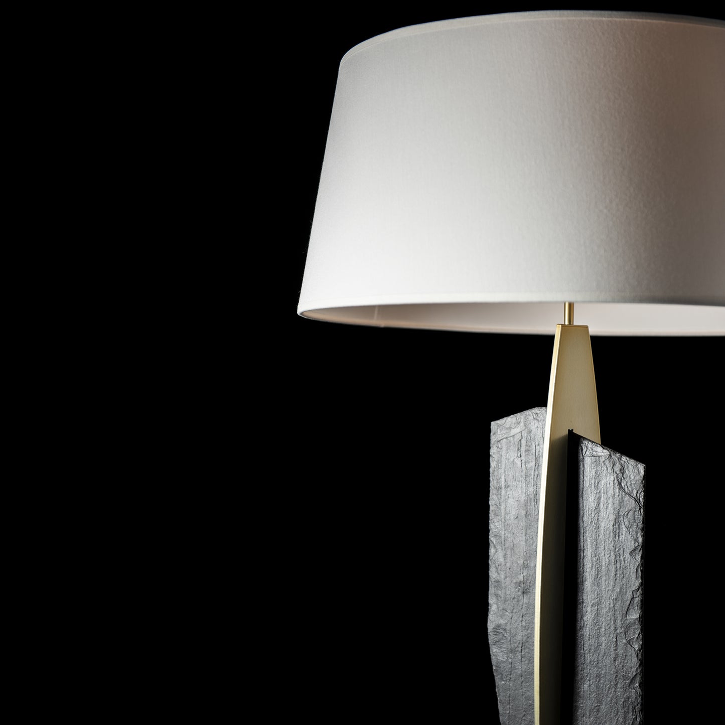 Hubbardton Forge Cambrian Table Lamp with a white shade and elegant handcrafted steel base.