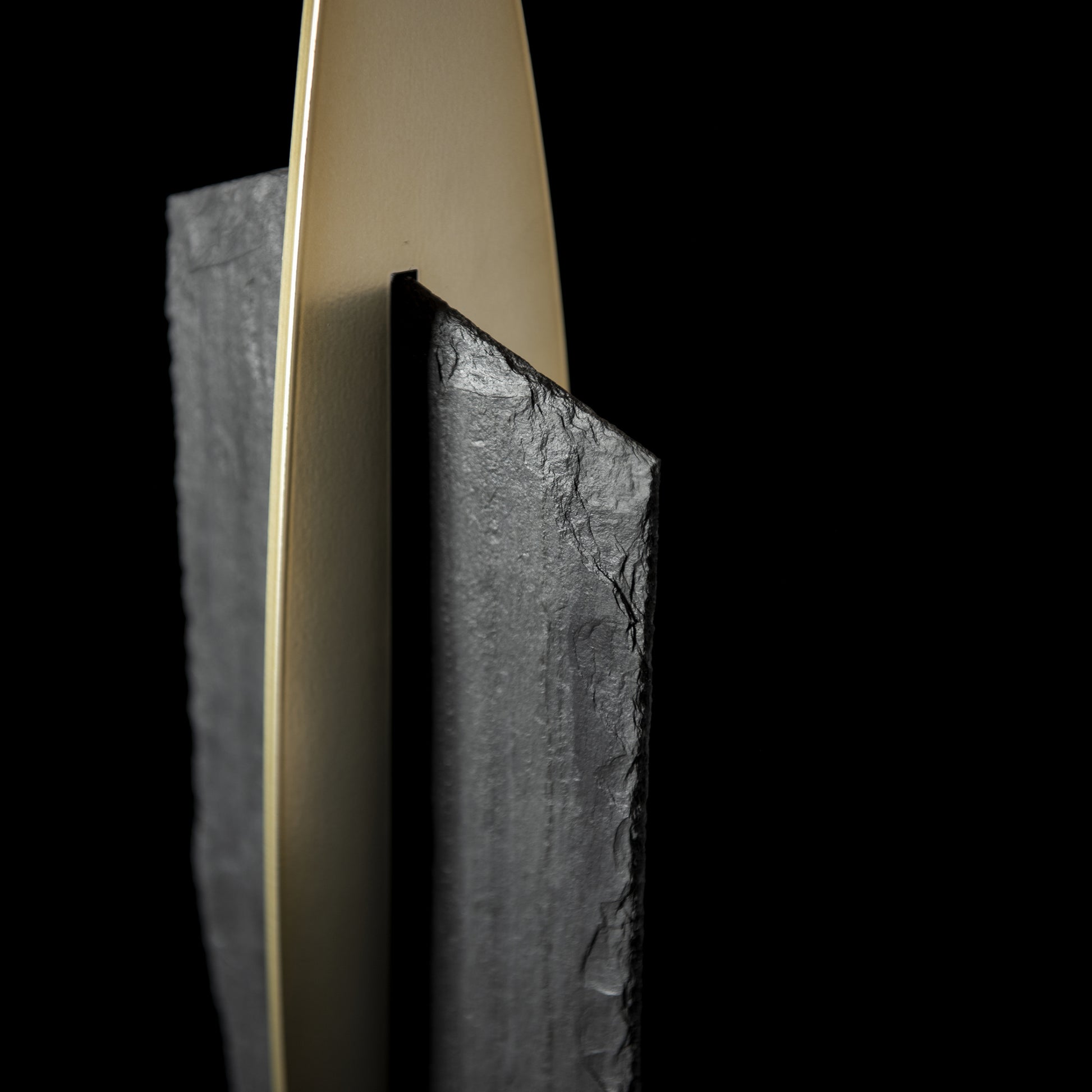 Hubbardton Forge Cambrian Table Lamp showcasing elegant steel slabs and a distinctive metallic blade design.
