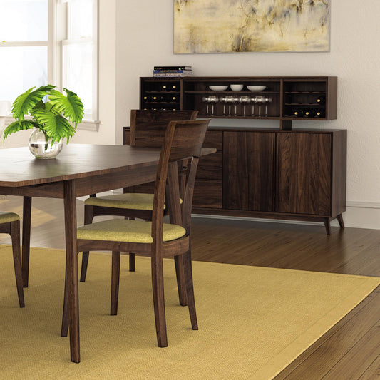 Solid wood dining table with four matching chairs and a Copeland Furniture Catalina buffet, showcasing American made craftsmanship.
