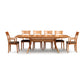 Catalina Trestle Extension Table by Copeland Furniture with six mid-century chairs featuring curved backs and dark upholstered seats, all crafted in premium wood.