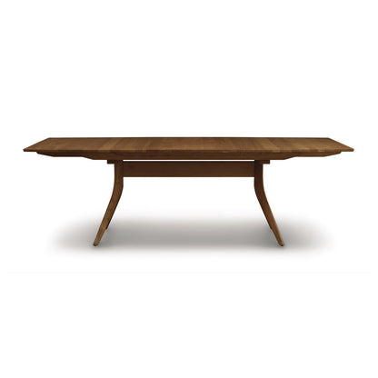 Copeland Catalina Trestle Extension Table made from solid American hardwood with angled legs and a smooth, polished top.