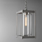 Cela Large Outdoor Lantern by Hubbardton Forge with clear glass panels, steel frame, and exposed bulb design hanging from a sturdy chain.
