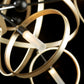 Celesse Pendant by Hubbardton Forge showcasing circular gold rings, tubular LED lights, and exquisite hand-forged steel craftsmanship.