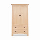 The Cherry Moon Armoire by Maple Corner Woodworks showcases Vermont craftsmanship with dark metal handles, crafted from solid wood.