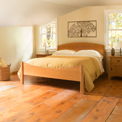 An eco-friendly bedroom with a Cherry Moon Bed from Maple Corner Woodworks and a handmade wooden floor.
