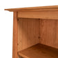 Close-up of the Maple Corner Woodworks Cherry Moon Bookcase highlighting the exquisite wood grain and craftsmanship details of its sustainably harvested hardwood shelves.