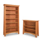 Cherry Moon Bookcases by Maple Corner Woodworks in natural wood; one tall with six shelves and one shorter with three shelves, showcasing a minimalist design crafted from sustainably harvested hardwoods.