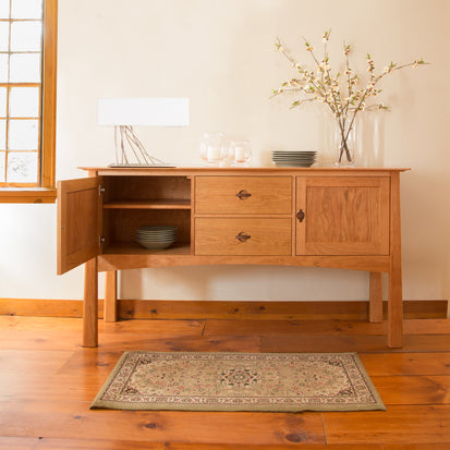 A luxurious Cherry Moon Hunt Board by Maple Corner Woodworks in an Asian-style room with a rug, providing extra storage space.