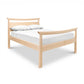 Cherry Moon Pagoda Bed by Maple Corner Woodworks with a light cherry finish, simple lines, white bedding, and two white pillows.