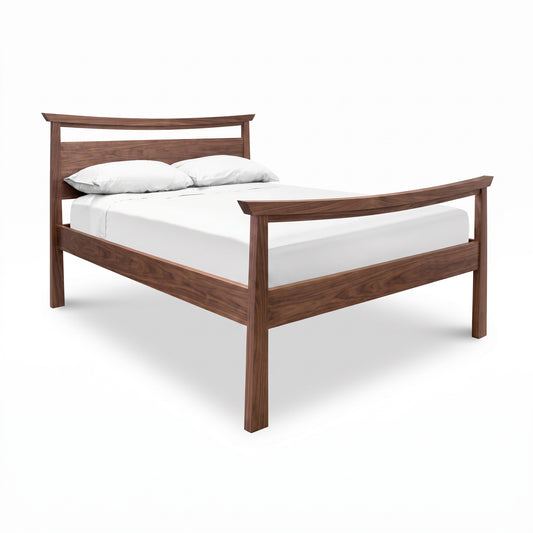 Cherry Moon Pagoda Bed by Maple Corner Woodworks with headboard, footboard, mattress, and two white pillows, crafted in solid wood.