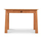 Cherry Moon Writing Desk by Maple Corner Woodworks in solid wood with light finish, straight legs, and single center drawer with round handle.