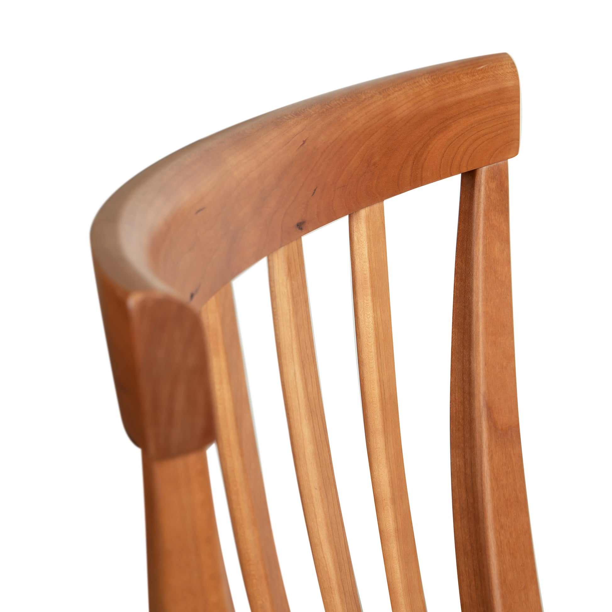Detail of the curved backrest and slats of the Lyndon Furniture Classic Shaker Arm Chair #1 – Floor Model, highlighting craftsmanship and design.